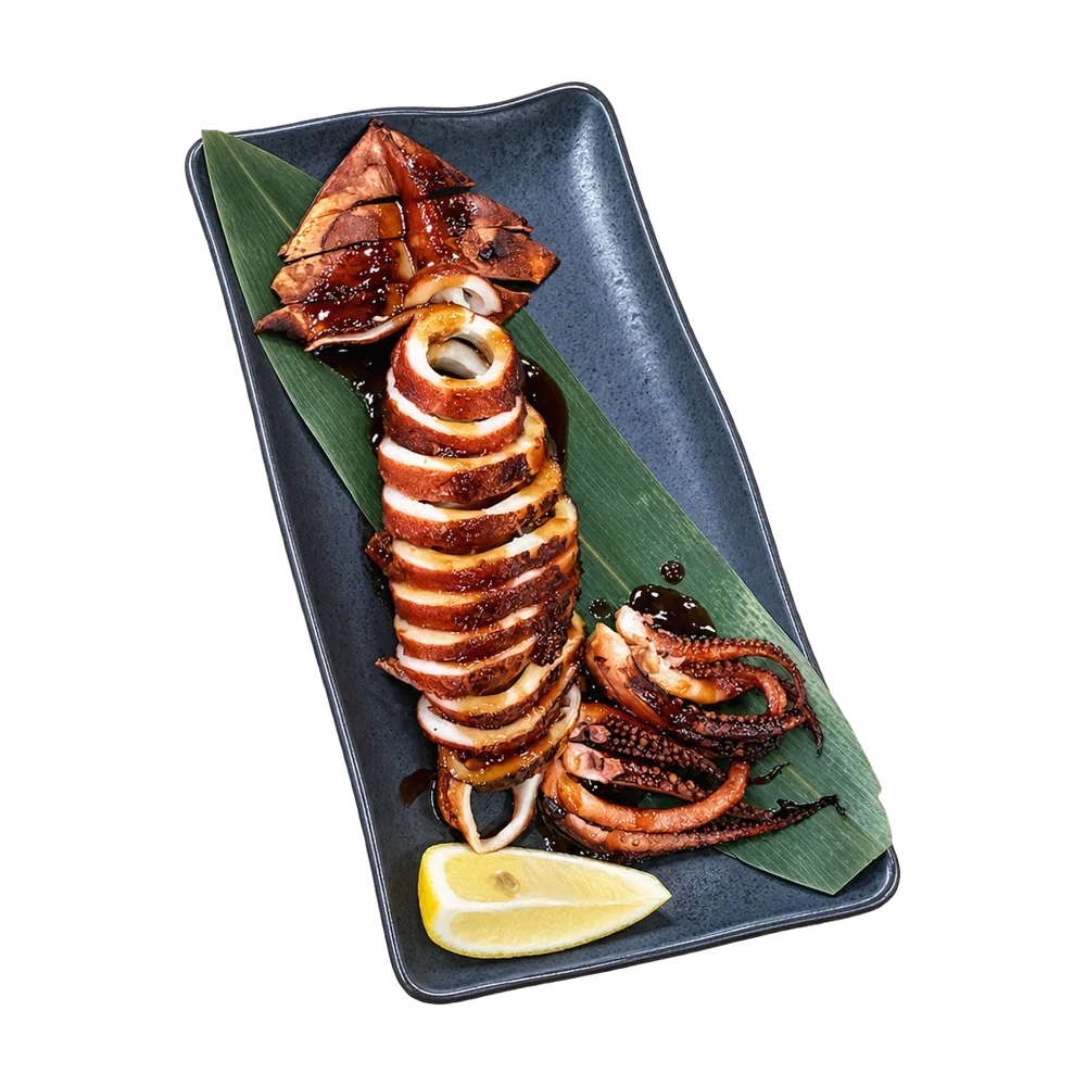 Grilled whole squid with teriyaki glaze and a lemon wedge