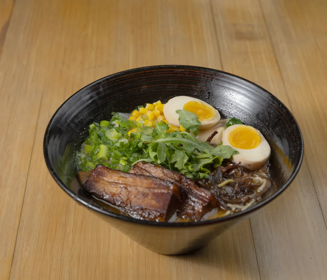 Tonkotsu ramen with pork belly, soft egg, corn and arugula