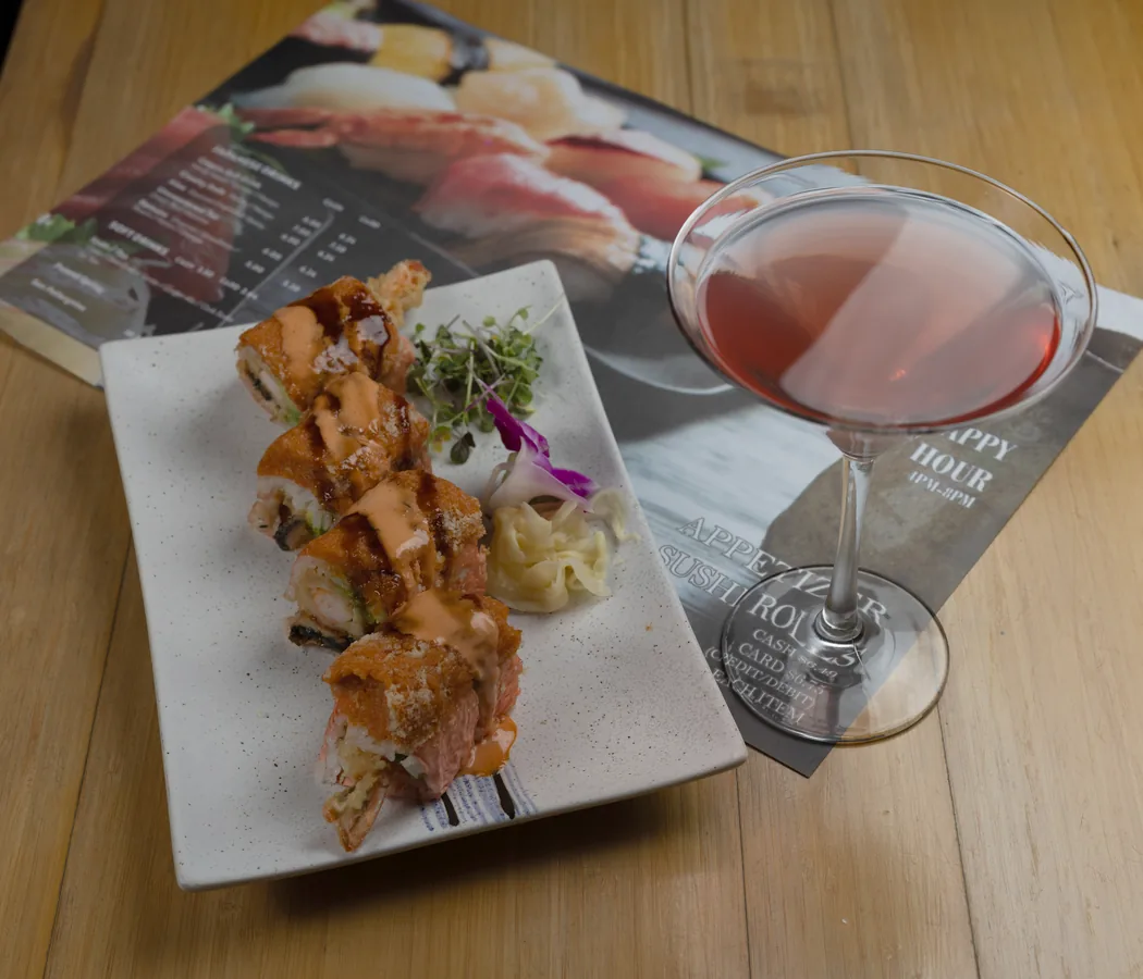 A seared sushi roll and a pink martini on the happy hour menu