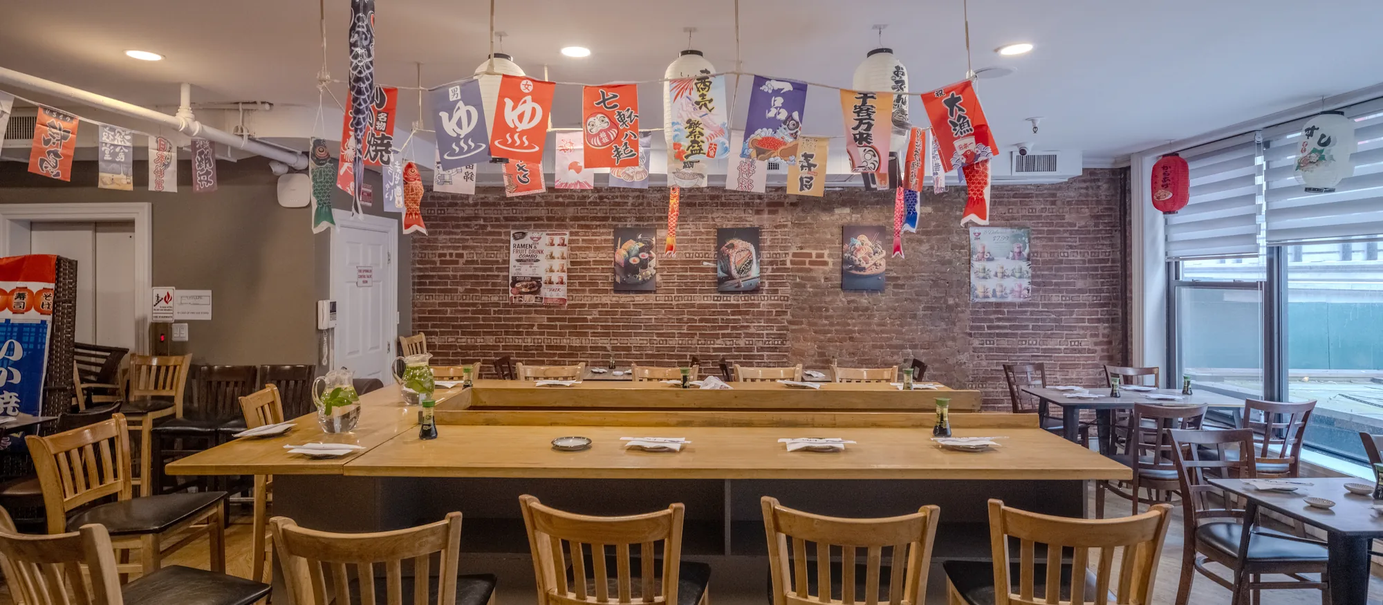 A long communal table set for a group in the Zen dining room