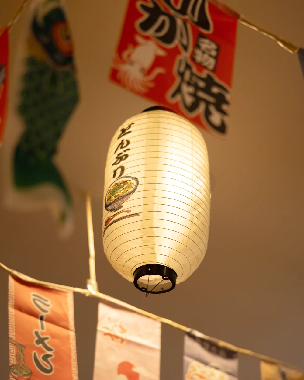 A paper lantern and hanging banners in the dining room